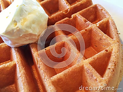 A Close Up Of A Waffle With Butter On Top Stock Photo