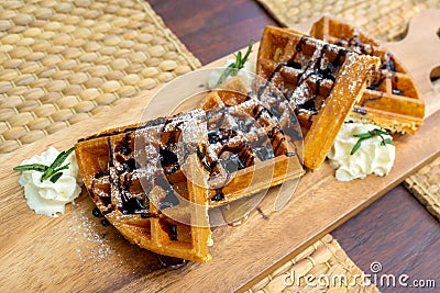 Close up waffles with chocolate and icing sugar on a plate Stock Photo
