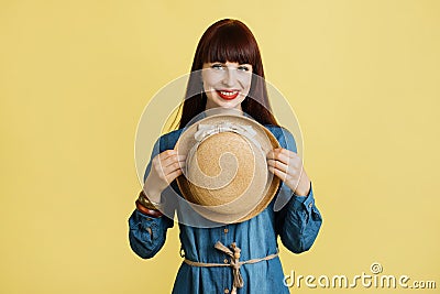 Close up waist up portrait of pretty young lady in casual trendy jeans dress and bright make up, demonstrating stylish Stock Photo