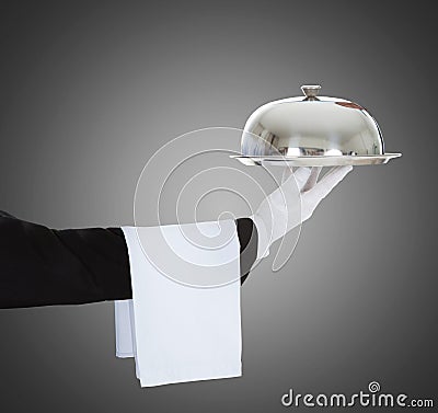 Waiter`s Hand Holding Cloche And Tray Stock Photo