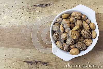 Close up of walnuts, hazelnuts and almonds on wooden table Stock Photo