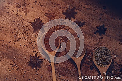 Close up of warm colourful various spices and herbs in wooden spoons Stock Photo