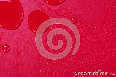 Close up of water drops on dark red tone background. Abstract red wet texture with bubbles on plastic PVC surface or grunge. Stock Photo