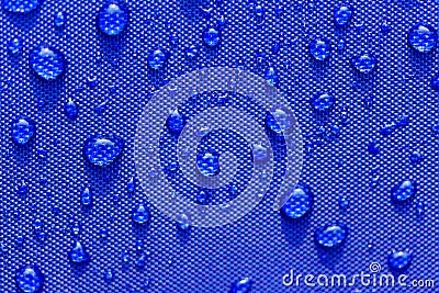 Close up Water drops pattern over a blue waterproof cloth Stock Photo