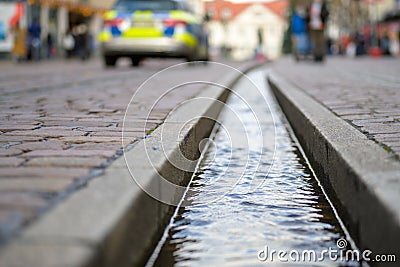 Close-up on water-filled runnel in the street Stock Photo