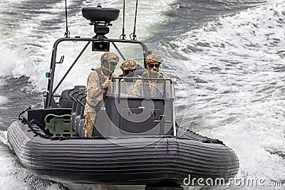 Close up of Water Police in camoflauge on high speed RIB on surveillance patrol on the Swan River, near Perth, Australia Editorial Stock Photo