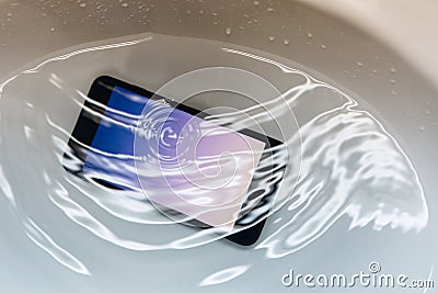 Smartphone Drop in to the Sink with Full of Water Stock Photo