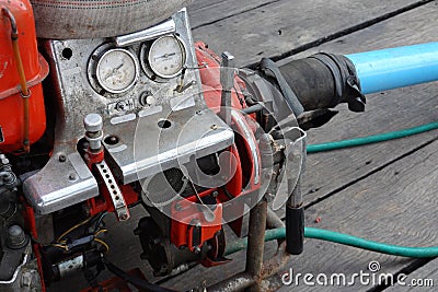 Water pumping gasoline engine old. Compound gauge water in and out tube. Stock Photo