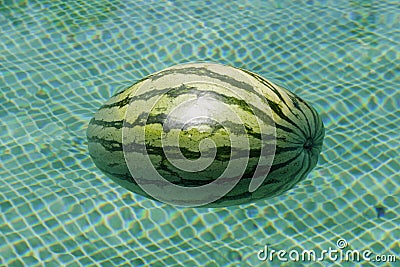 Close-up of watermelon floating in a swimming pool Stock Photo