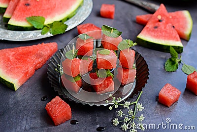 Close-up of watermelon sliced in the form of canapes on a metal plate on a gray background Stock Photo