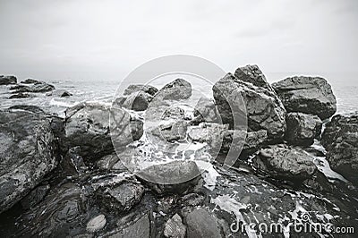 Close-up of waves beating on beach. Rocky sea shore. Top view Stock Photo