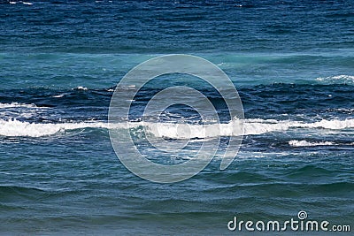 Close up of Waves Breaking Ripples on Sea Shore Stock Photo