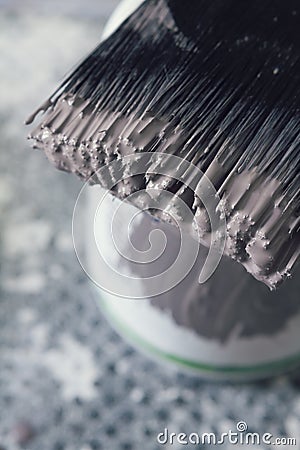 Close up of wet paint on brush bristles overhead vertical Stock Photo