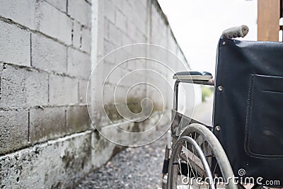 Close up wheelchair outdoor with concrete wall. Stock Photo