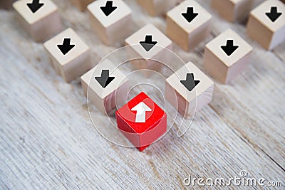 Close-up white arrow icon on cube wooden toy block stacked with pointing to opposite directions for way of adapting to change Stock Photo