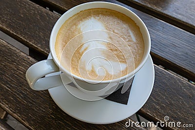close up of white brown frothy foam in the cup of cappuccino. Softness of drink. Breakfast time in the morning at cafe Stock Photo