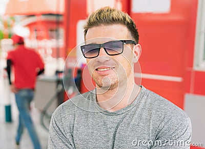 Close up white caucasian happy smile in front of fuel nozzle tank after filling high energy power fuel into auto car tank in Stock Photo