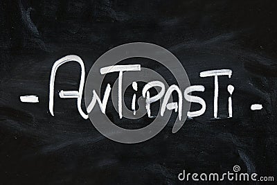 White chalk ANTIPASTI word over black chalkboard Stock Photo