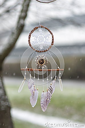 Close up white dream catcher bohemian craft rainy day outdoors Stock Photo