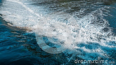 Close up of white, fast flowing, turbulent water flowing over dam on river Stock Photo