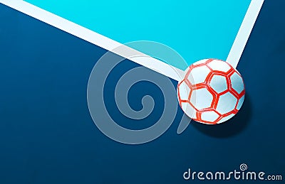 Close-up of a futsal soccer ball laying on the line in the corner of a blue indoor soccer field Stock Photo