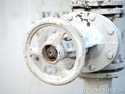 Close-up of white and little rusty pressure control shutoff valve Stock Photo