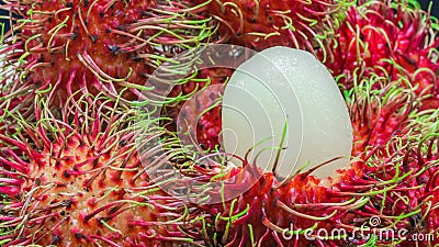 Close up of white pulp rambutan among red Stock Photo