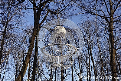 Close up of white unusual interesting shape lantern or lamp hanging on trees with almost no leaves. Lamp made of Stock Photo