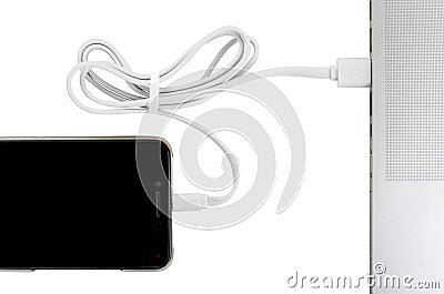 Close-up white usb cable connect phone and laptop computer new technology concept Stock Photo