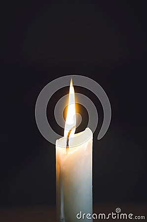 Close up of white wax lit candle flame and wick on black background. candle lights macro. closeup of burning candle isolated on Stock Photo