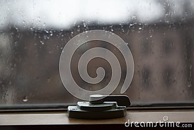 Close up of window latch. Window hasp. Rain drops on a glass Stock Photo