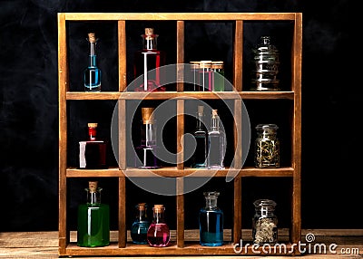 Close up of witch shelves with potion bottles. Medieval alchemist laboratory with various kind of flasks Stock Photo