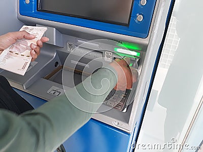 Withdraw money from ATMs Stock Photo