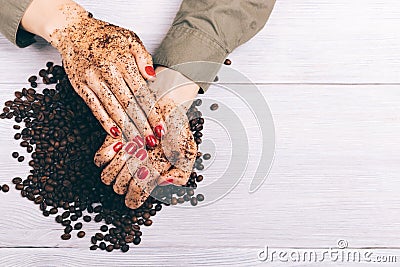 Close-up of a woman applying coffee scrub to her hands Stock Photo