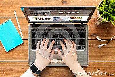 Close up of woman blogging on laptop Stock Photo