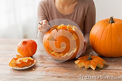 Close up of woman carving halloween pumpkin Stock Photo