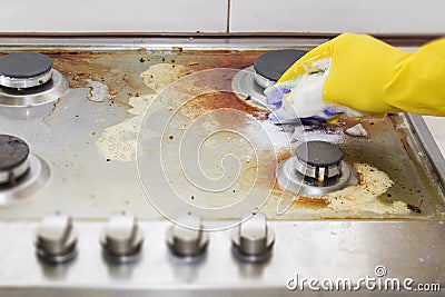 Close up of woman cleaning cooker at home kitchen Stock Photo