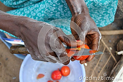 Close-up of woman cutting tomatoes, Tanzania Stock Photo