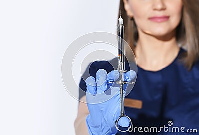Close-up of woman dentists hand in glove with syringe full of anesthesia for pain relief injection before tooth curing Stock Photo