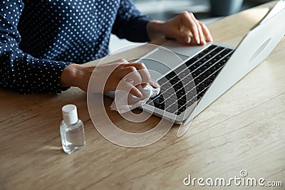 Close up of woman disinfect laptop with sanitizer Stock Photo