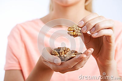 Close Up Of Woman Eating Walnuts Stock Photo