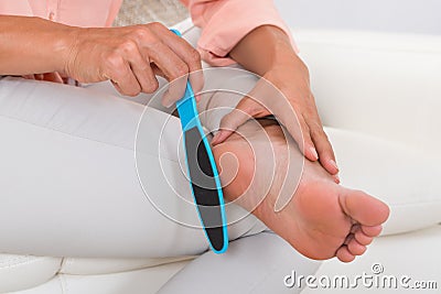 Close-up Of Woman Filing Foot Stock Photo