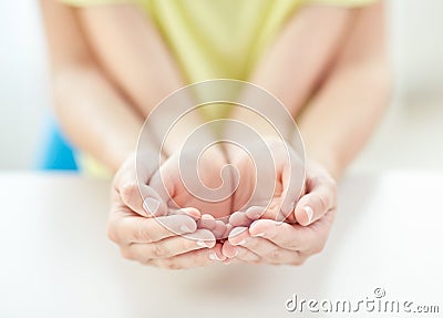 Close up of woman and girl with cupped hands Stock Photo