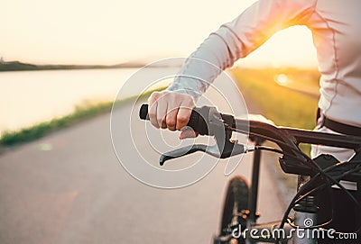 Close up woman hand on the bicycle handlebars Stock Photo