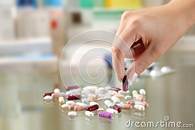 Woman hand catching a pill from a group Stock Photo