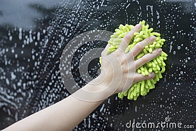 Close up woman hand hold a brush washing over the black car,woman can wash concept,woman can do concept Stock Photo