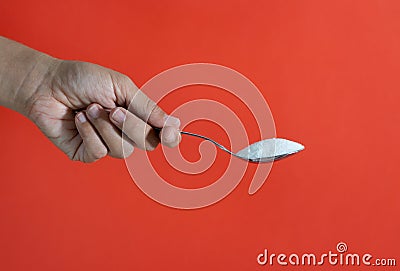 Close up of woman hand offering coffee spoon full of sugar in of sugar addiction too much calories concept Stock Photo