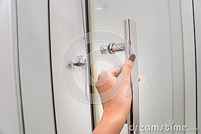 Close up woman hand pull the shower door in luxury bathroom Stock Photo