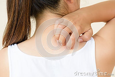 Close up woman hand scratch the itch by hand at neck and back. Stock Photo