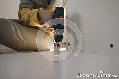 Close up of woman hand using cordless screwdriver Stock Photo